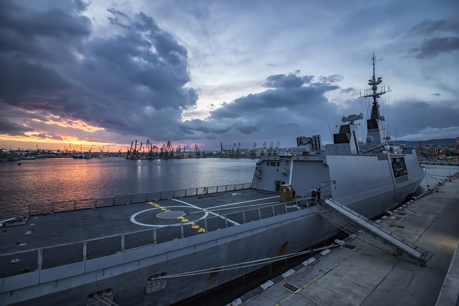 Part of frigate naval forces at sunset at the port. Warship